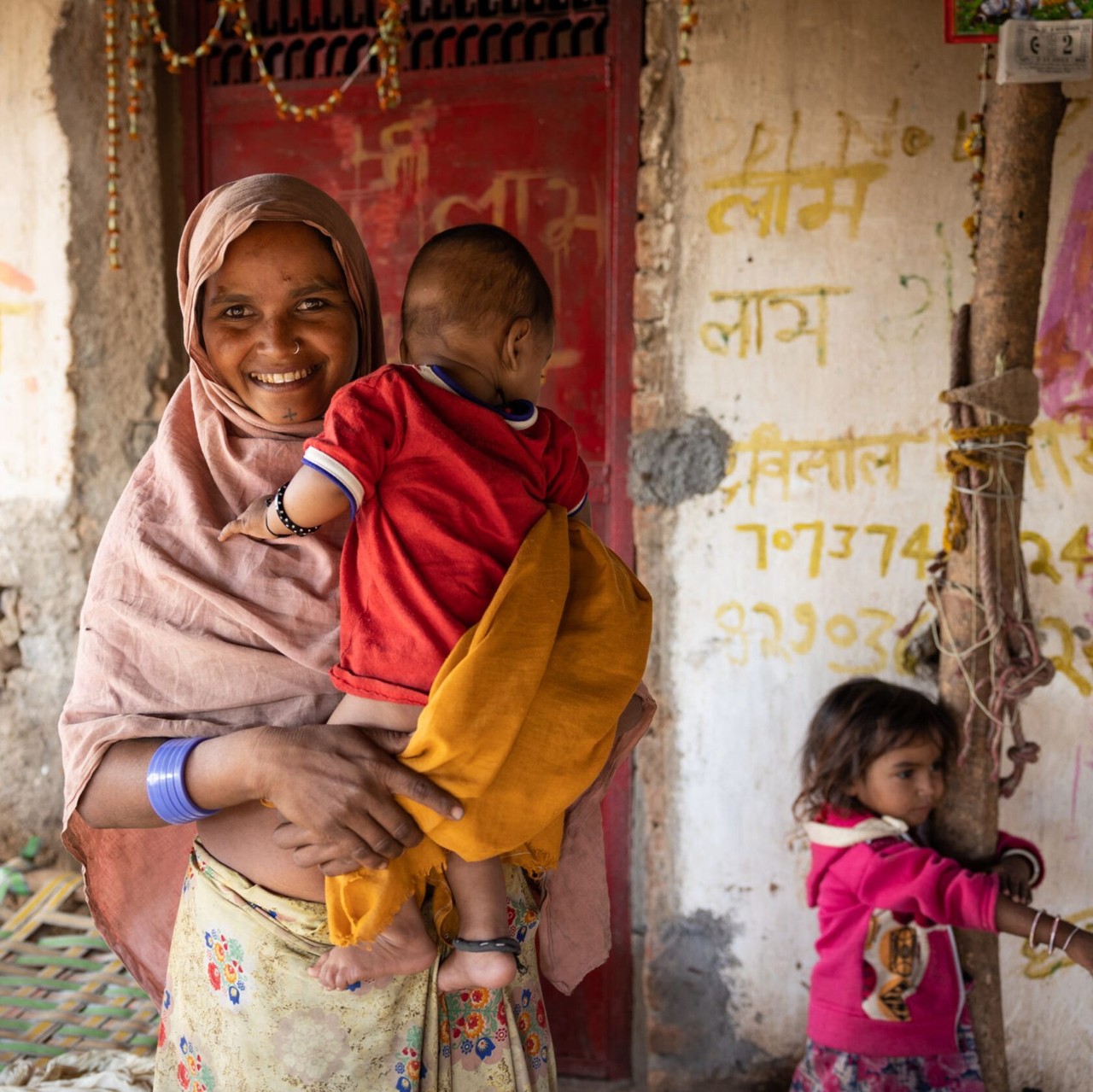 Tipu Bai, a mother of three children, poses after speaking with a Taruni Sakhi (community volunteer) who provides counseling on reproductive health and contraceptive choices.